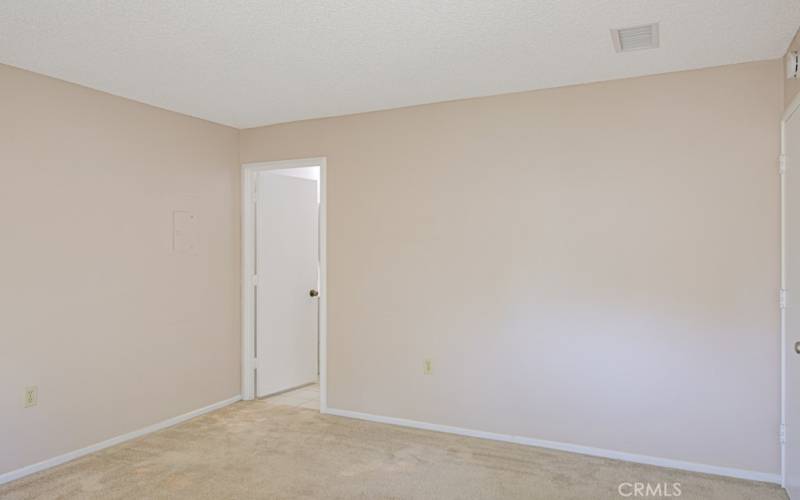 Another view of the primary bedroom. Doorway opens to primary bathroom.