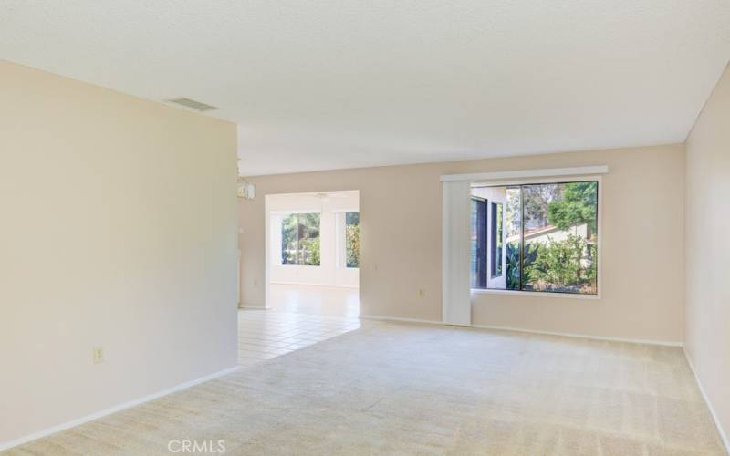 View of living room from the entry. Dining area and bonus room can be seen at rear.