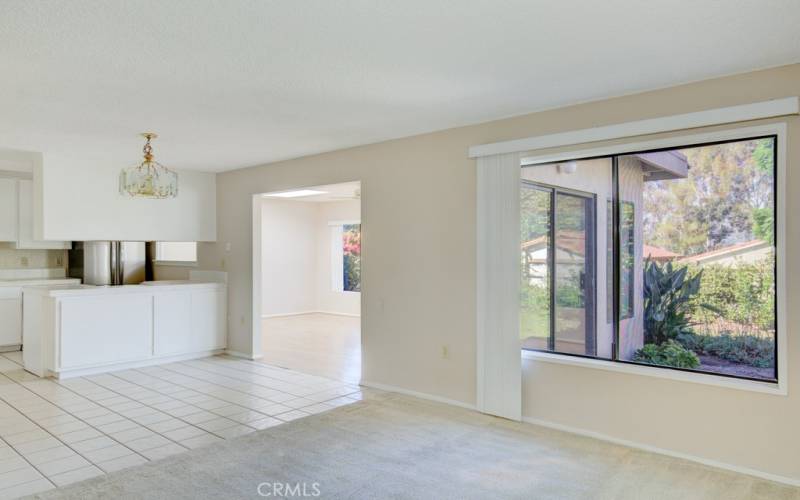 View of the dining area, kitchen and entry to the bonus room as seen from the living room.