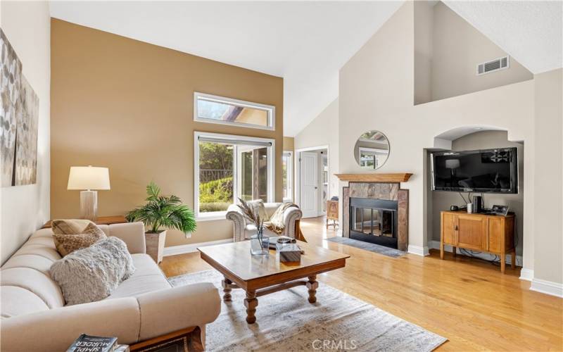 The living room is anchored by a gas fireplace, offering a cozy focal point.