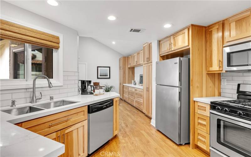 Extended kitchen will delight the chef with custom cabinetry, beautiful quartz counters, and suite of stainless appliances.