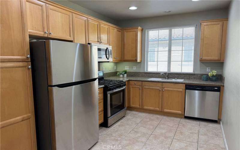 Kitchen features granite counters and stainless steel appliances