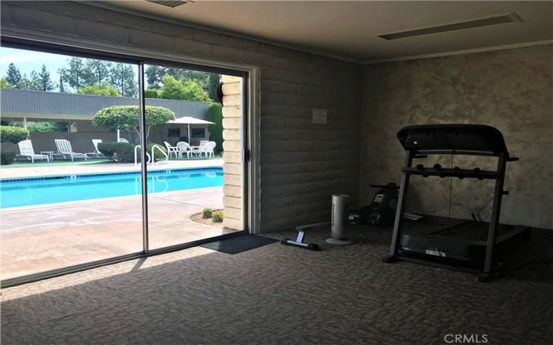 EXERCISE ROOM W/VIEW TO POOL.