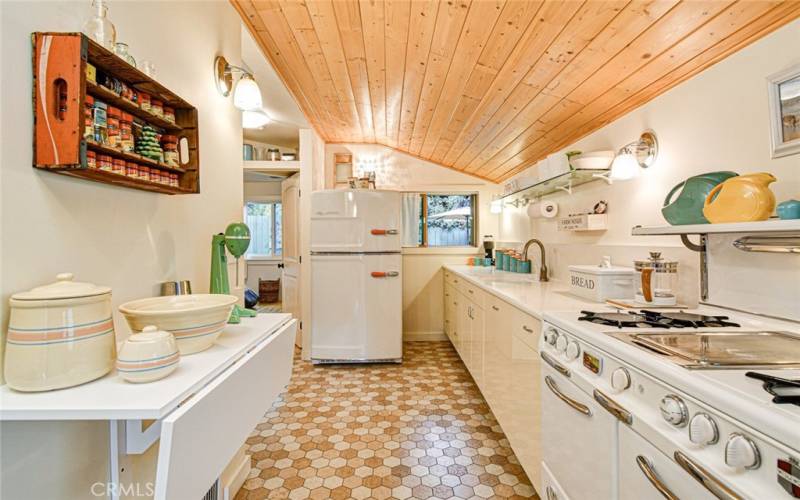 Vintage stove and newer refrigerator stay with the house.