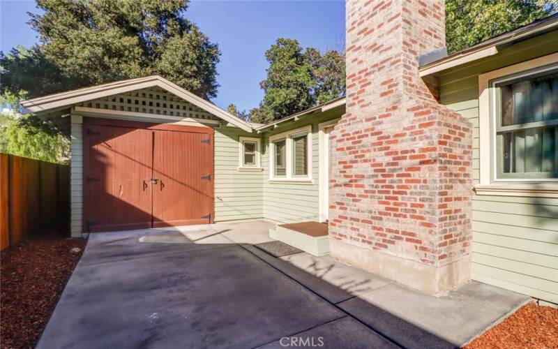 Chimney in place and vintage garage doors.