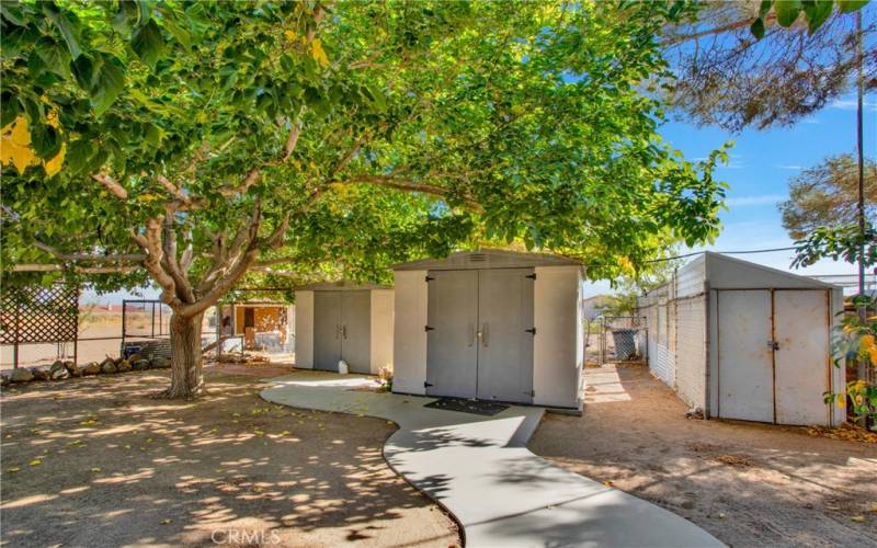 Rear yard storage sheds X 3, additional Large storage container behind those.