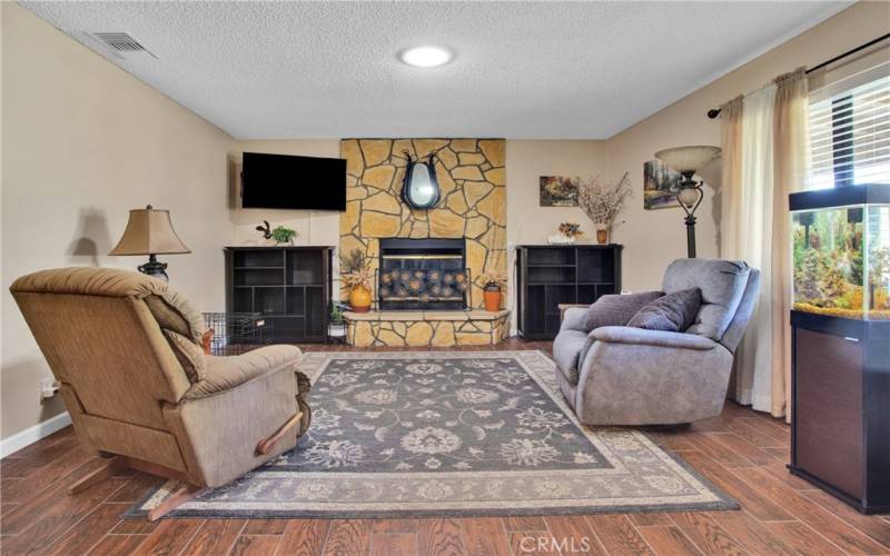 Living room with picture window to Landscaped front yard.