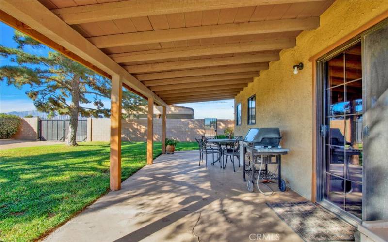 Rear patio looking to front of home and Front Gate to rear drive thru.