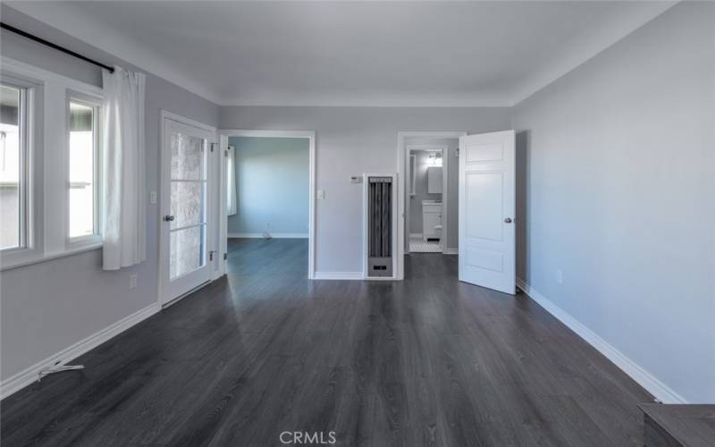 Living room looking towards bedroom with french doors and and bathroom (on right)