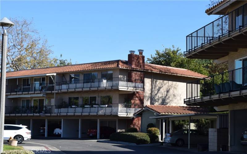 view of the balcony side of 3014A Lower condominium with wrap around balcony, small roofed building is the conviently located community laundry facility.