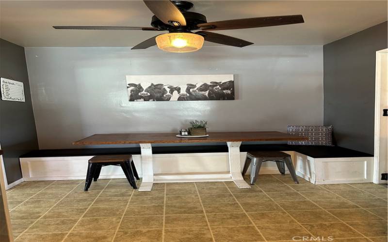 The eating area has a built-in banquette seating with storage underneath and a custom made table that stays with the home!