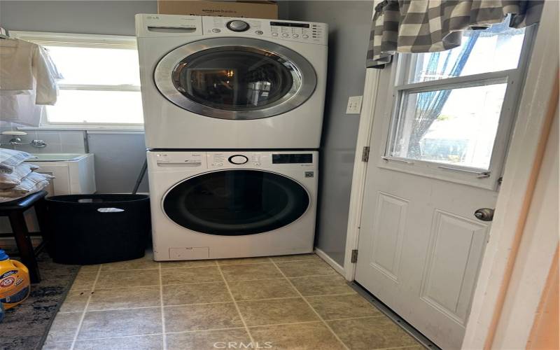 Laundry room has a utility sink, pantry cabinet and enough room for full size washer and dryer.