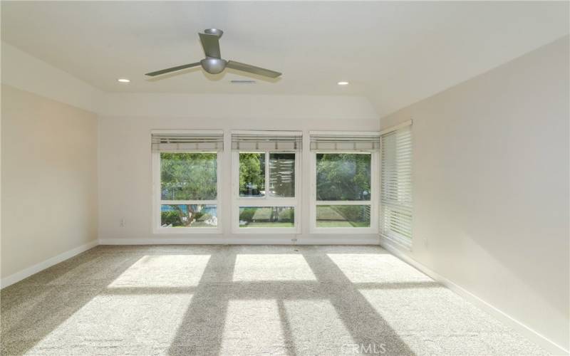 Expansive window offers sunshine and tree views.