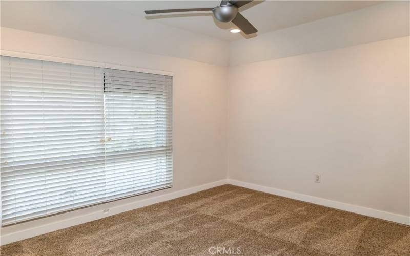 Light and bright bedroom with over sized window.