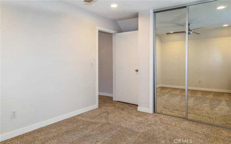 Mirrored closets and fresh carpet.