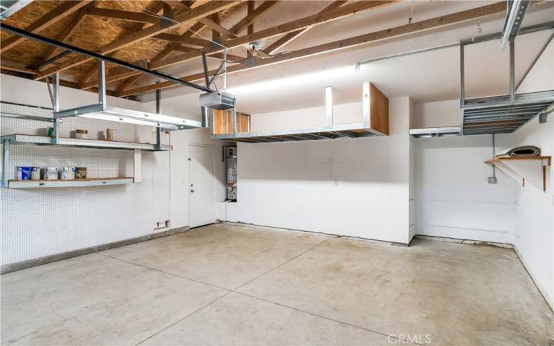 2 car garage with storage spaces/shelves