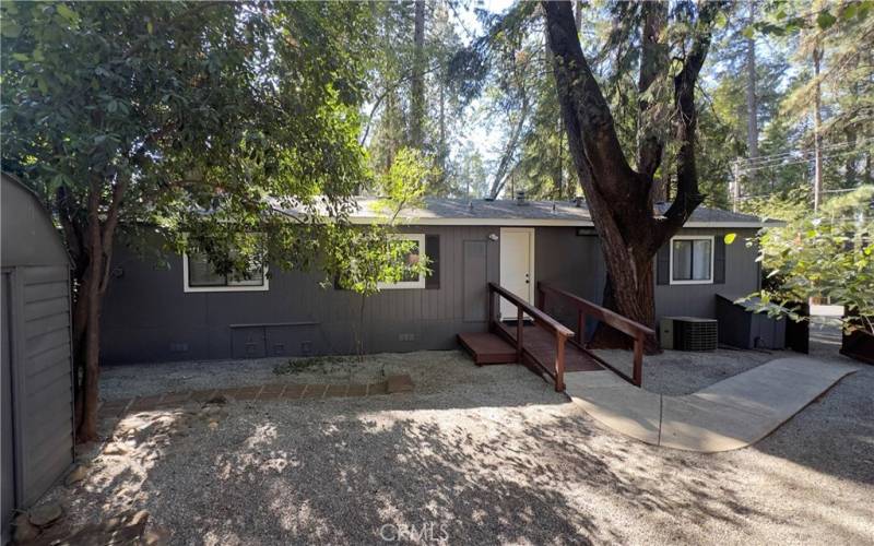 view of back entrance to laundry room and gate to front parking area