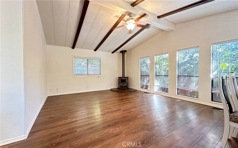 Living space with vaulted ceilings and fan