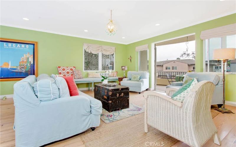 Living Room with plenty of comfy seating and french doors  leading to balcony