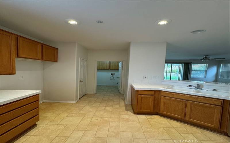 View of Kitchen into connected laundry room.