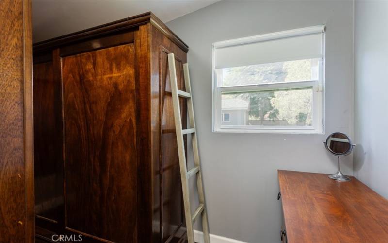 Primary bedroom walk in closet with wardrobes