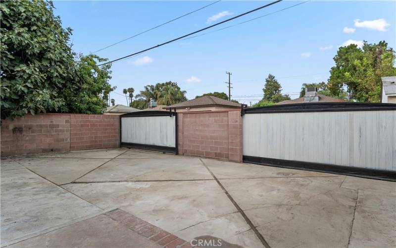 Back yard space for many cars or trucks.