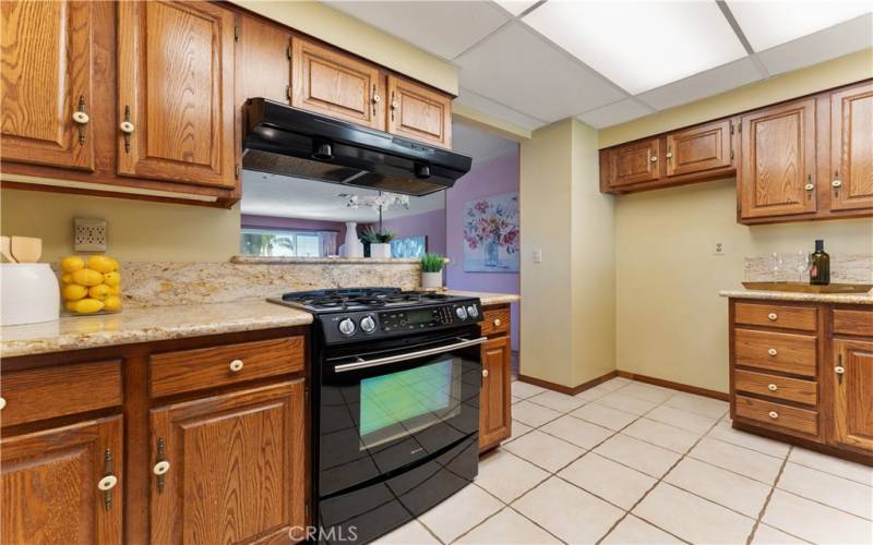 Granite counters, custom cabinets, pass through to dining.