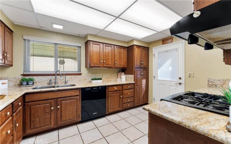 Custom cabinets made from the family patriarch. Side door has encased blinds. Window overlooks the patio.