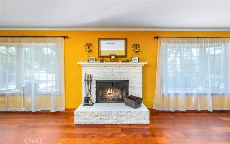 Enhanced photo with fire in the formal living room fireplace