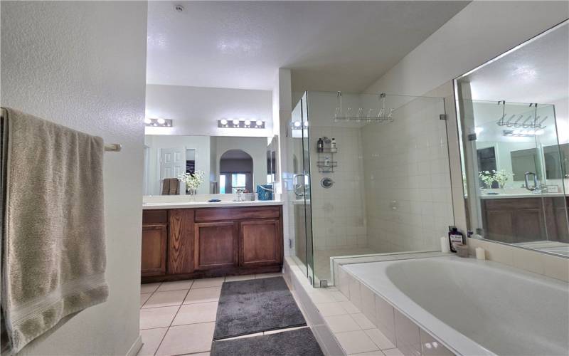 En suite primary bathroom has a shower and separate soaking tub as well as separate toilet room and walk in closet.