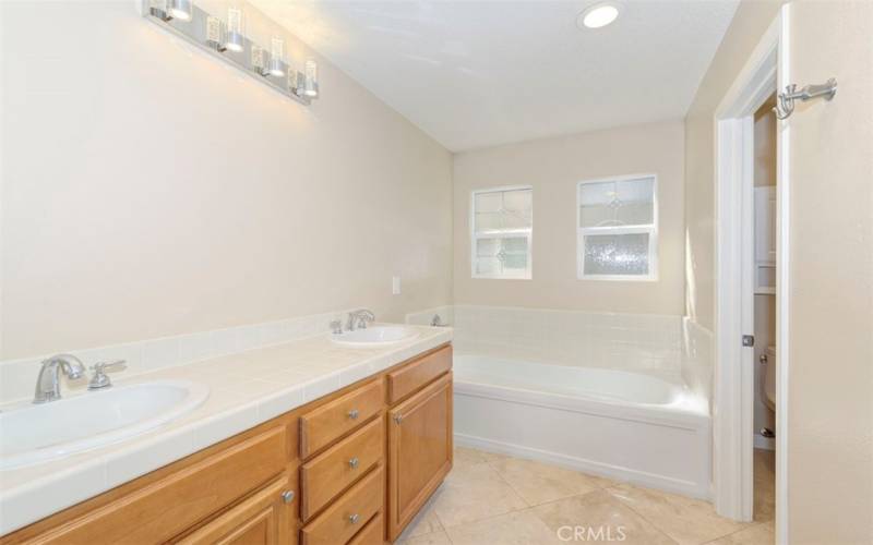 Primary Bathroom with dual sinks, soaking tub and walk-in shower ~