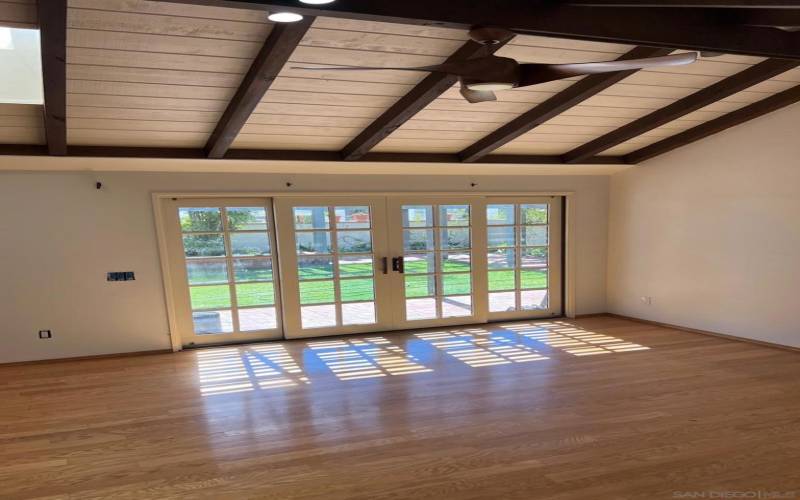 French doors lead to fenced in backyard and patio