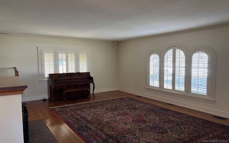 Gleaming hardwood floors in spacious living room. Owner would leave piano and rug or remove.