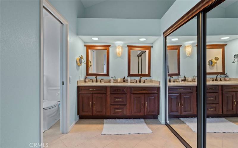 Primary En-Suite Bathroom.  Walk-in closet to the right and separate shower/tub on the left.