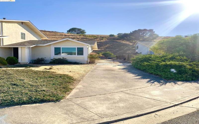 The second parking area in the front of the house leads to the large back yard.