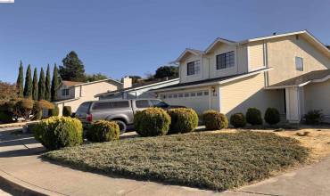 Notice that this 1985-BUILT home has 2 parking pads in the front of the house. Covered front porch.