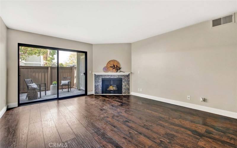 Wood style laminate flooring and cozy fireplace in living room