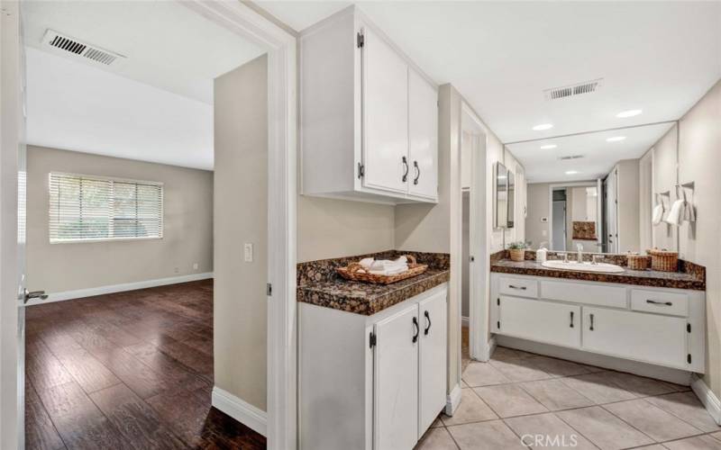 Primary bathroom is sizable with extra storage and counter space