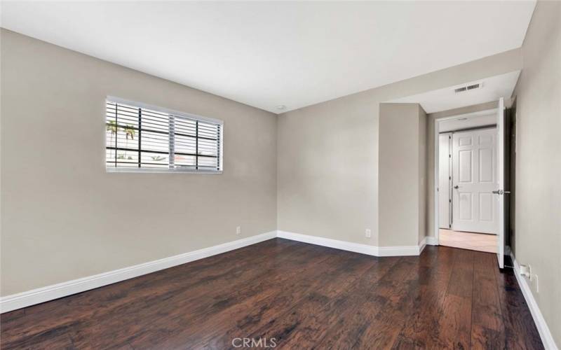 Two windows in the primary bedroom add to bright living