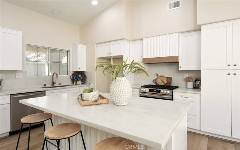 Designer touches throughout including white oak, slatted vent hood and champagne brass hardware and faucet.