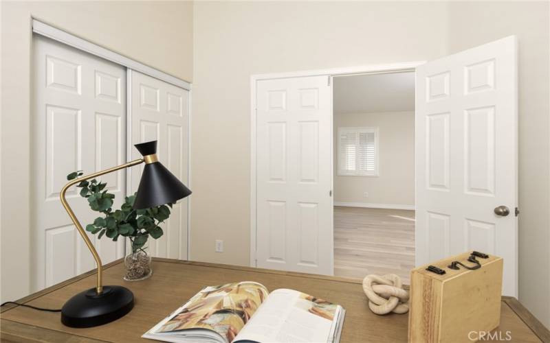 Double doors and a closet make this space versatile .