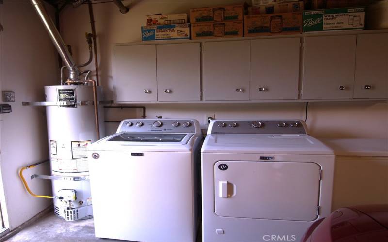 Garage has blt. in work bench, cabinets above washer/dryer area + updated water heater.