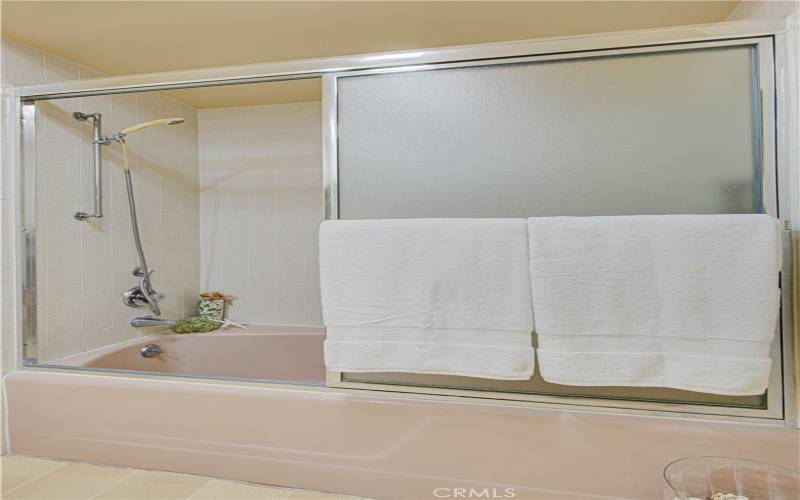 Guest bathroom has a tub/shower combination.