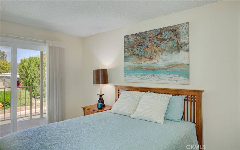 Guest Bedroom has a sliding glass door leading out the the balcony.