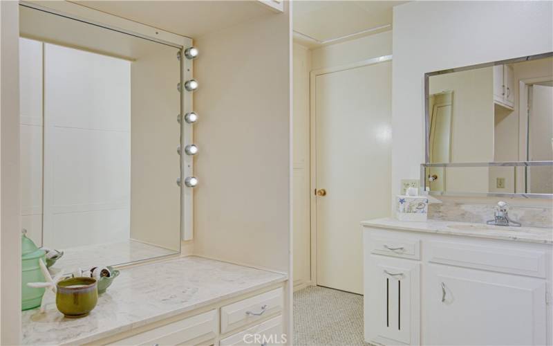 Showing both vanities and looking towards the entry into the master suite.