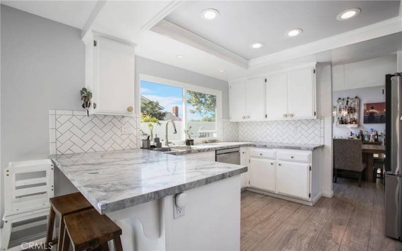 Updated Kitchen with quartz counter tops and white cabinets.