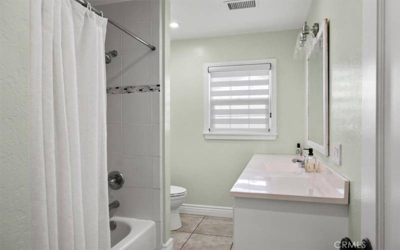 Hallway bathroom with tub/ new tile and remodeled bathroom