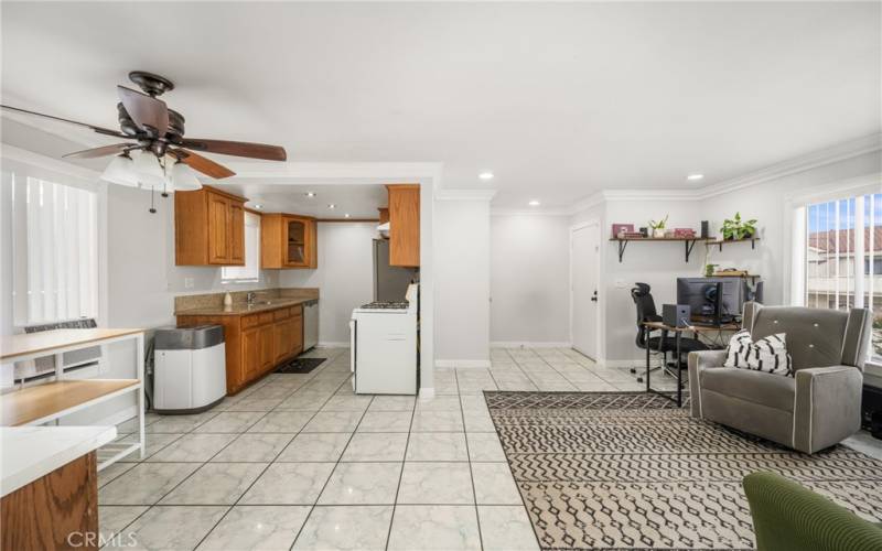 View from the Hall into the Kitchen and Living/Dining Area. Note the stylish ceiling fan/light and granite counters! New vent hood over the range, too!