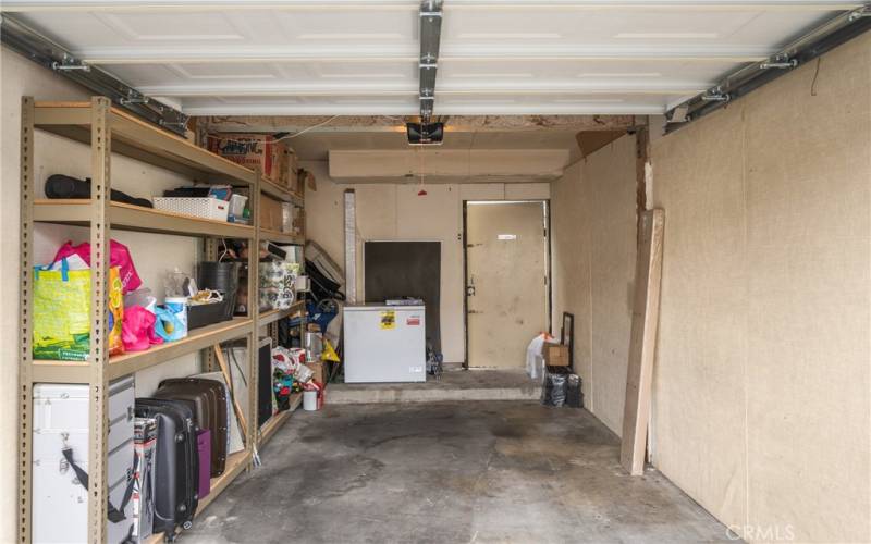 Spacious 1-car garage with storage shelves and new roll-up door!