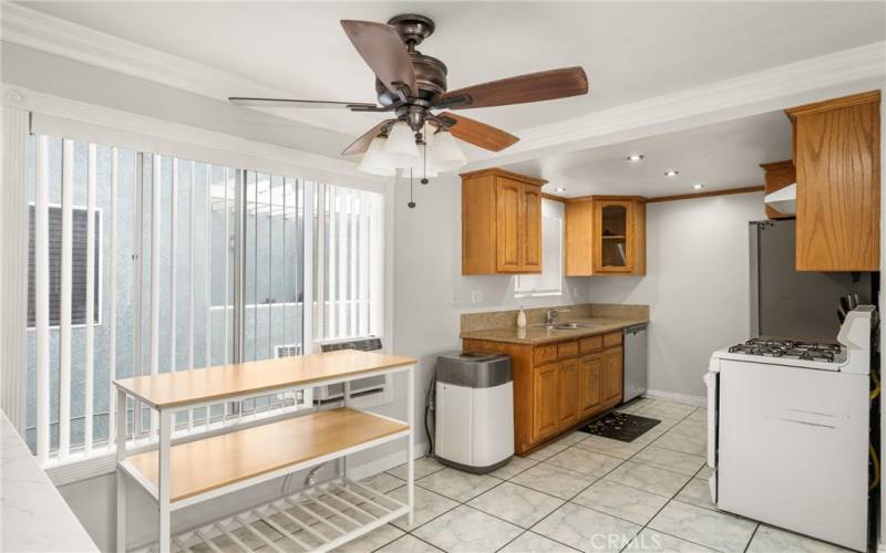 Near floor-to-ceiling windows bring in an abundance of light! Note portable clothes washer and window AC unit included in the sale! And mini-recessed lighting in the Kitchen, too!